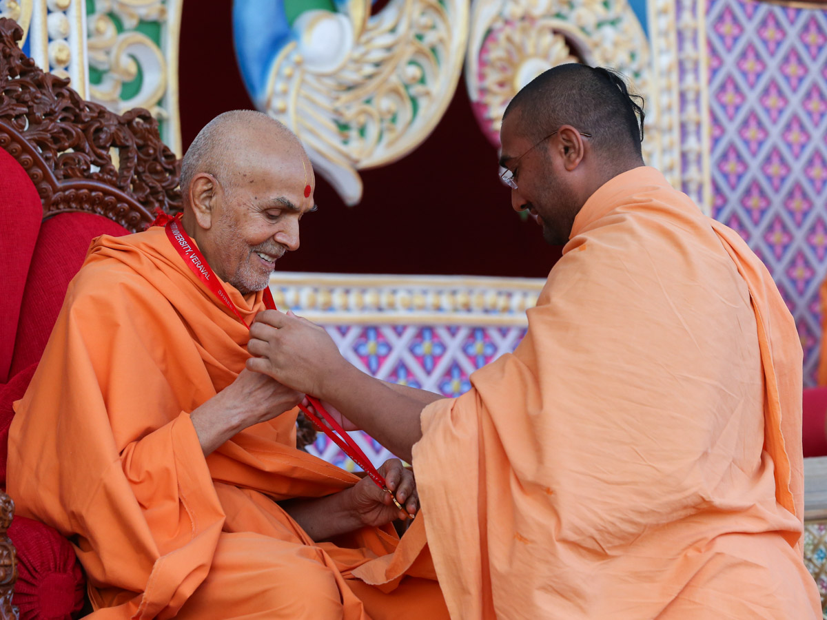 Swamishri blesses Mangalvardhan Swami on his achievement of getting a Gold medal in MA from Somnath University