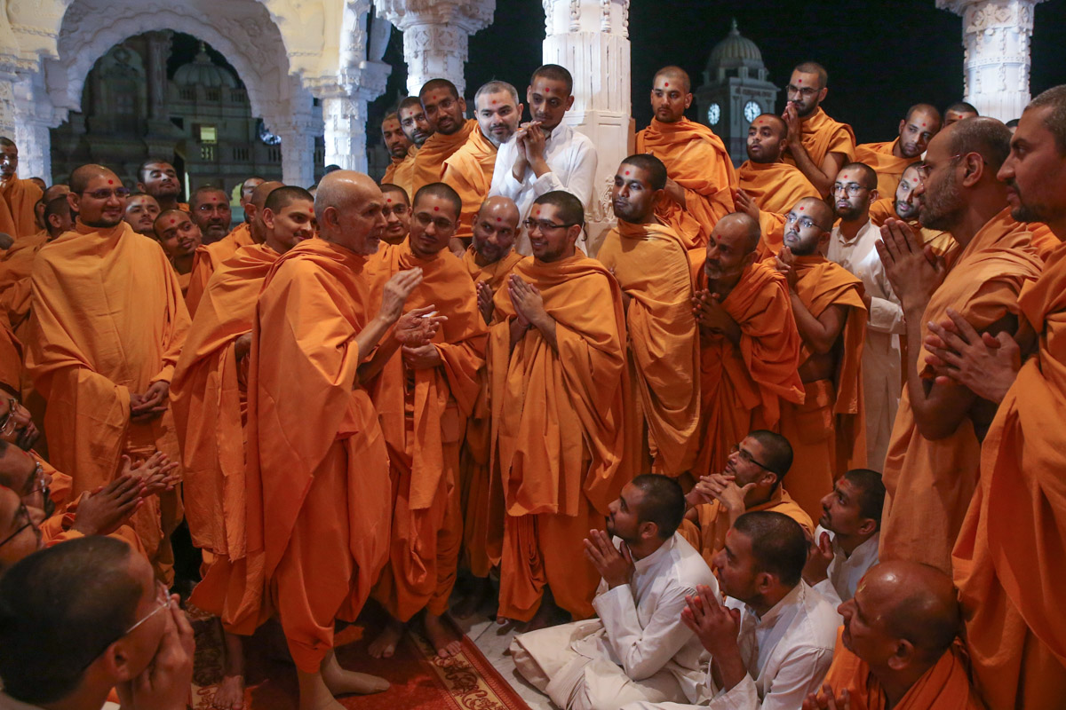 Swamishri converses with sadhus and sadhaks in the mandir pradakshina