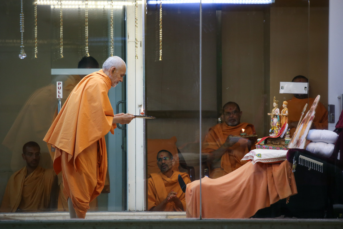 Swamishri performs the evening arti in the Pramukh Mandiram