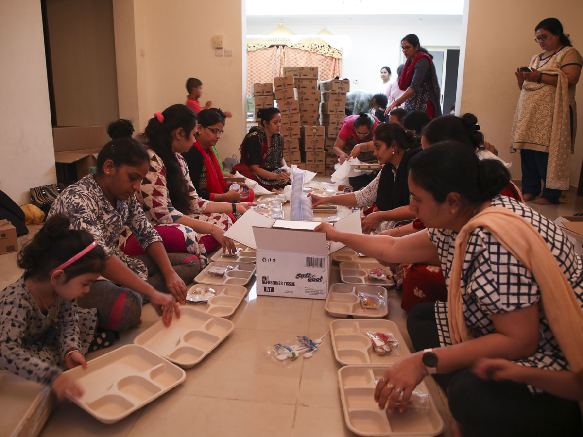 Volunteers prepare the mahapuja trays