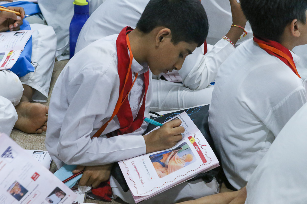 Balaks write notes during a shibir session