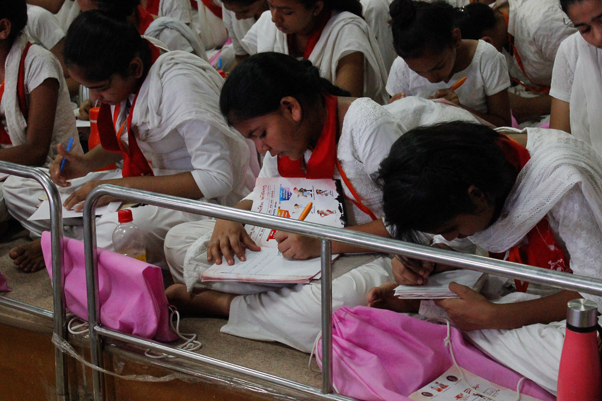 Balikas write notes during the shibir session