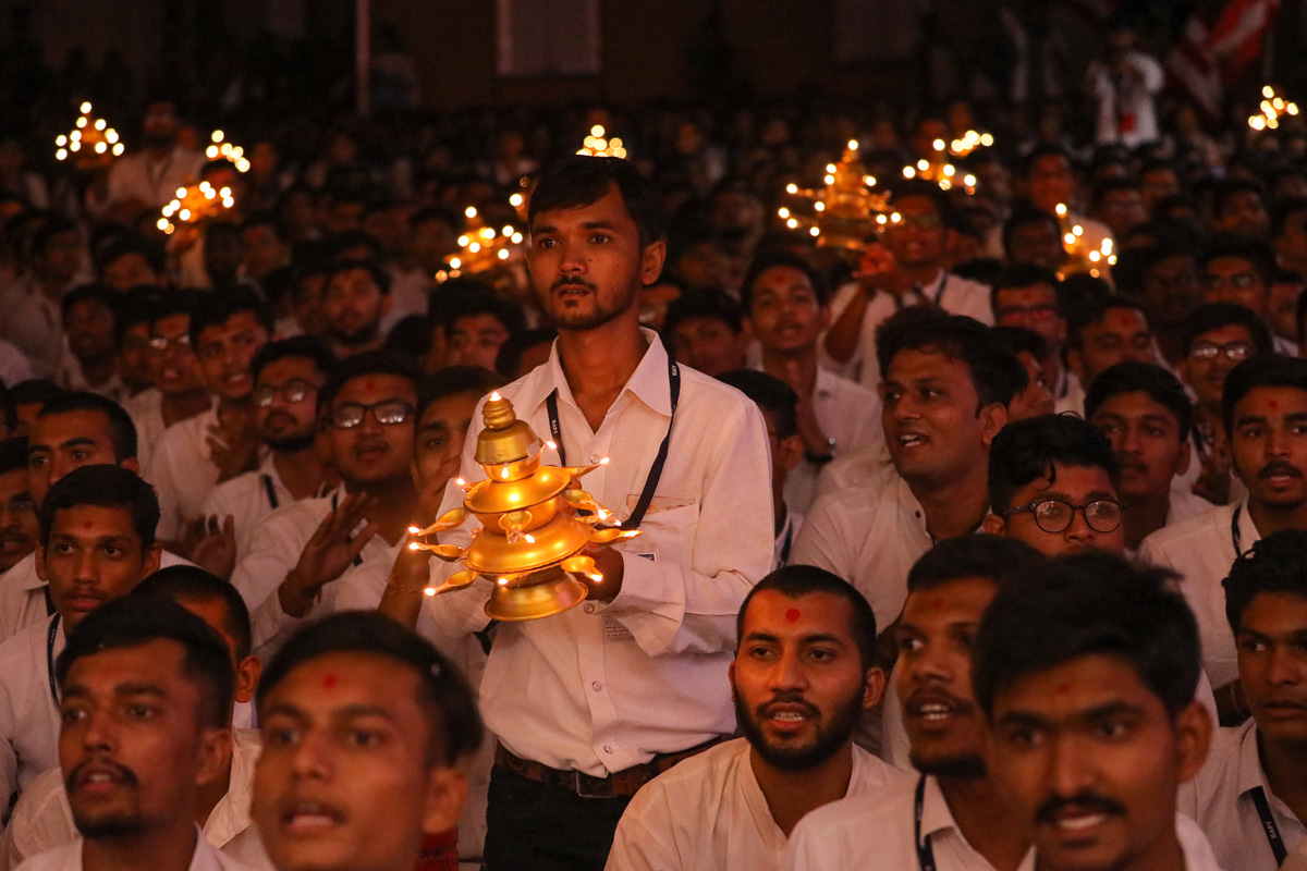 Youths perform the arti
