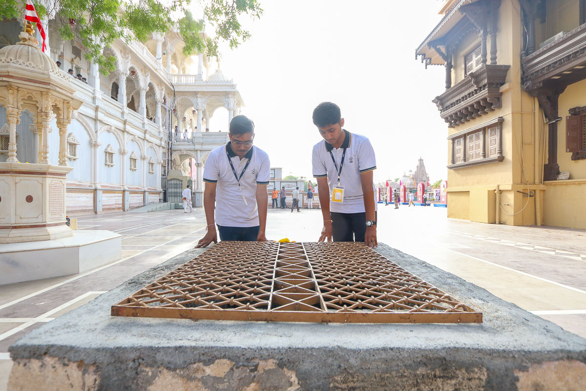 Youths doing darshan of the old well