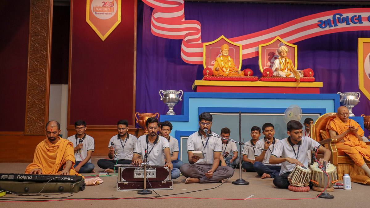 Youths sing kirtans at the start of the shibir