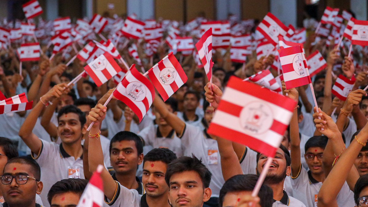 Youths wave BAPS flags
