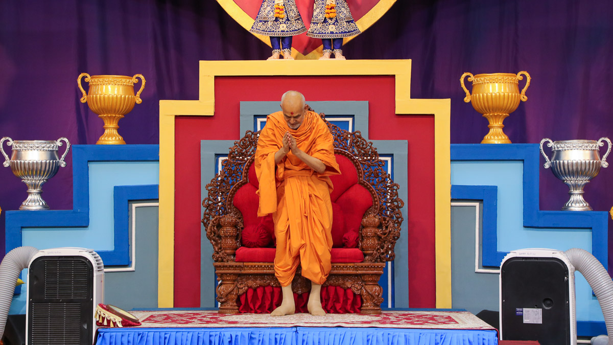 Swamishri bows to everyone with folded hands
