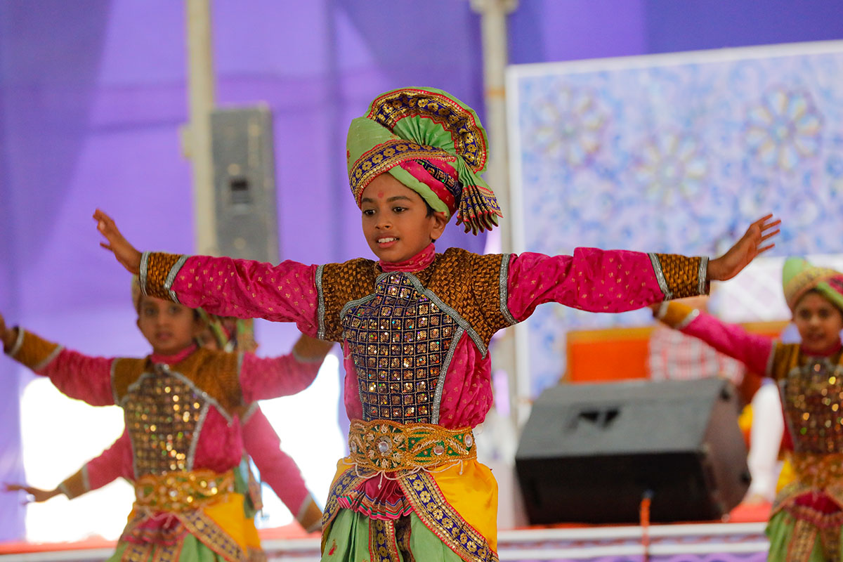 Children perform a traditional dance in the Shilanyas Mahotsav assembly