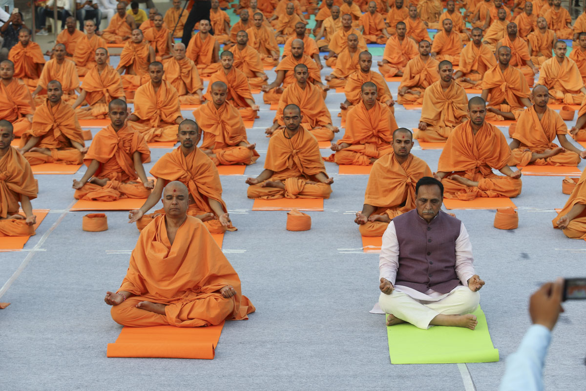 CM Vijaybhai Rupani and sadhus perform yoga