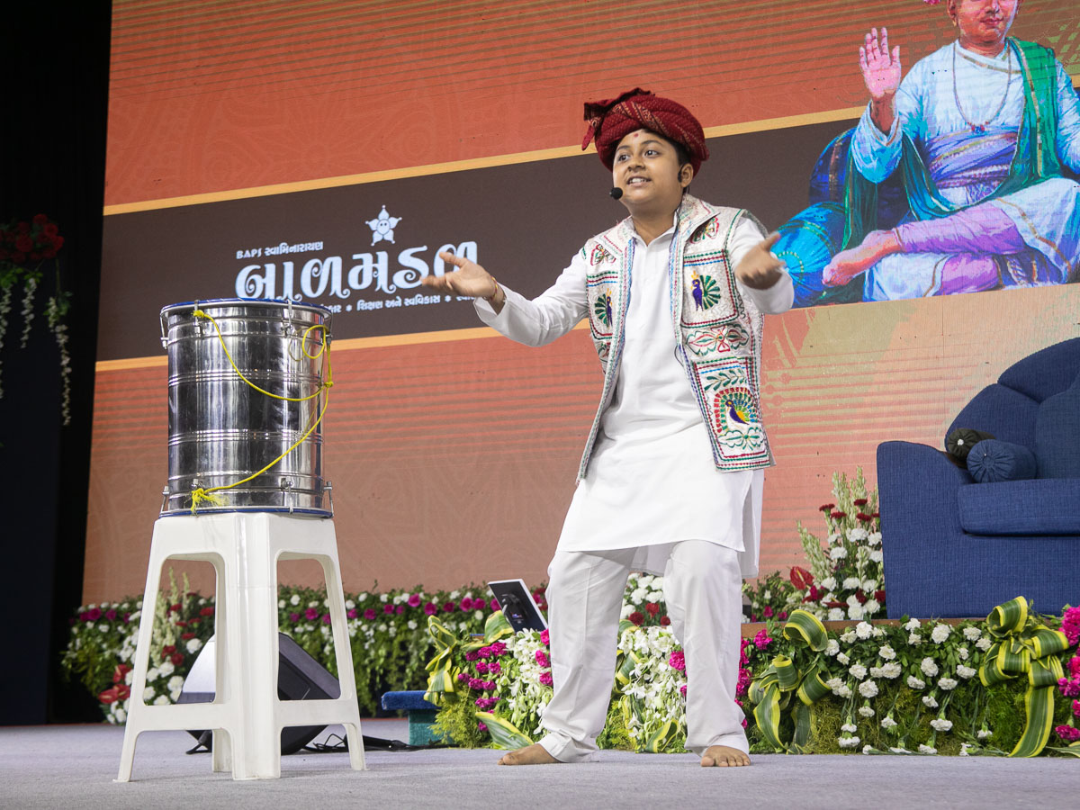 A child presents a mono act in the evening Bal Din assembly