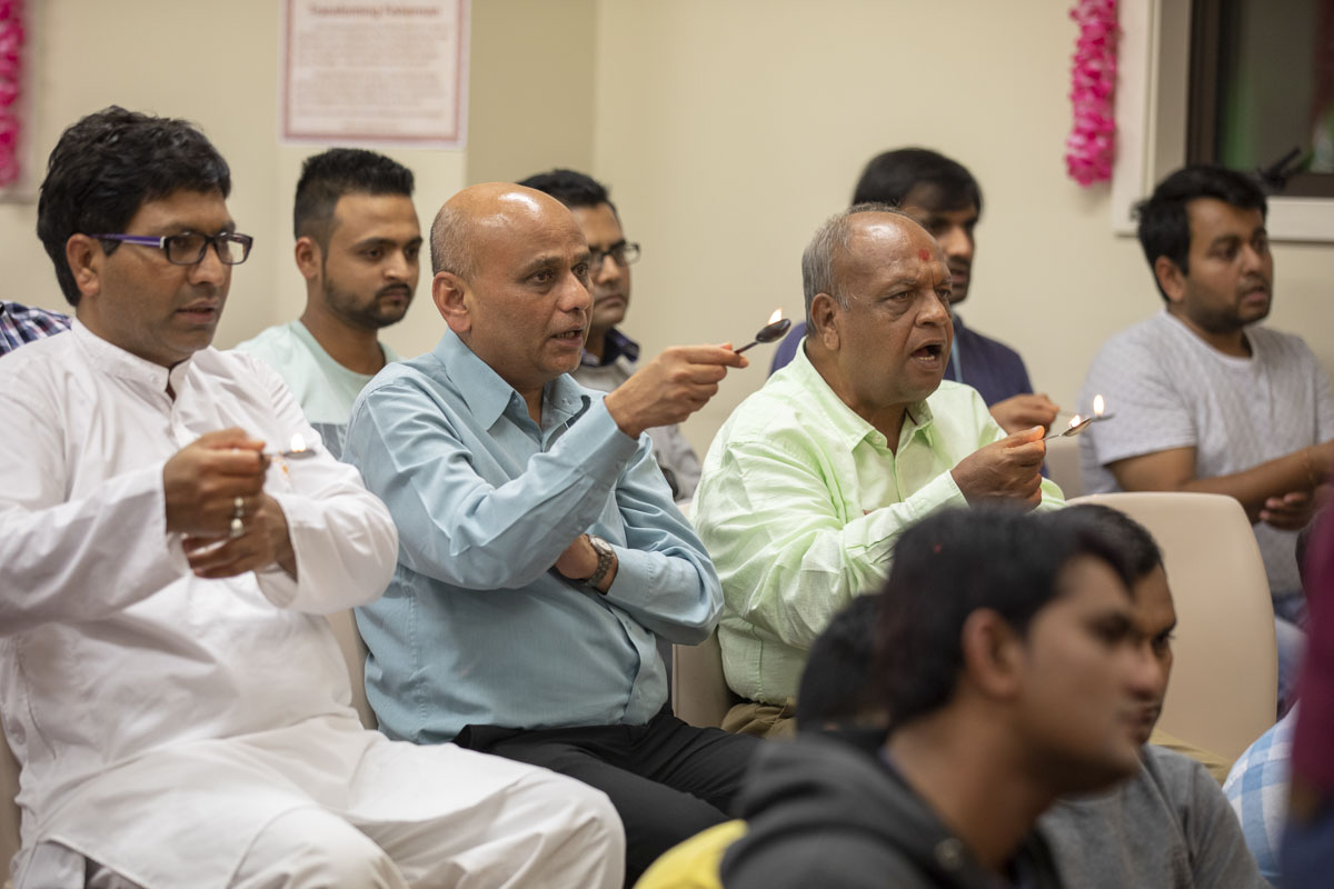Devotees perform the arti