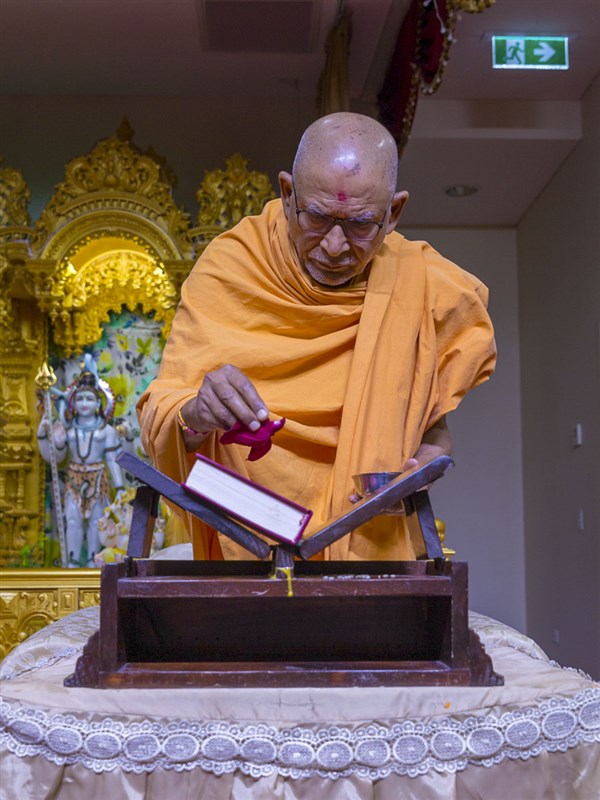 Pujya Kothari Swami performs pujan of the Vachanamrut