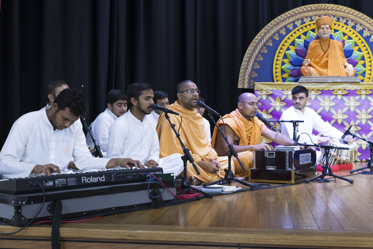 Sadhus and youths sing kirtans in the assembly
