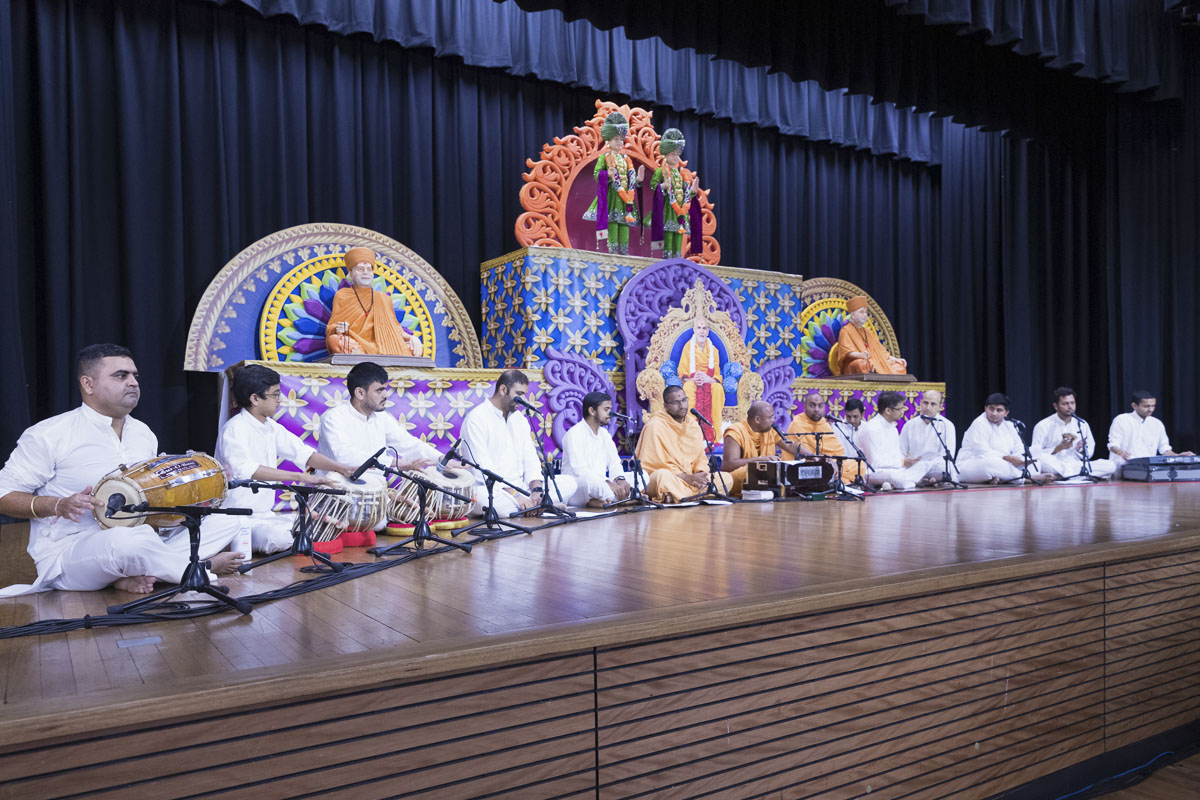 Sadhus and youths sing kirtans in the assembly