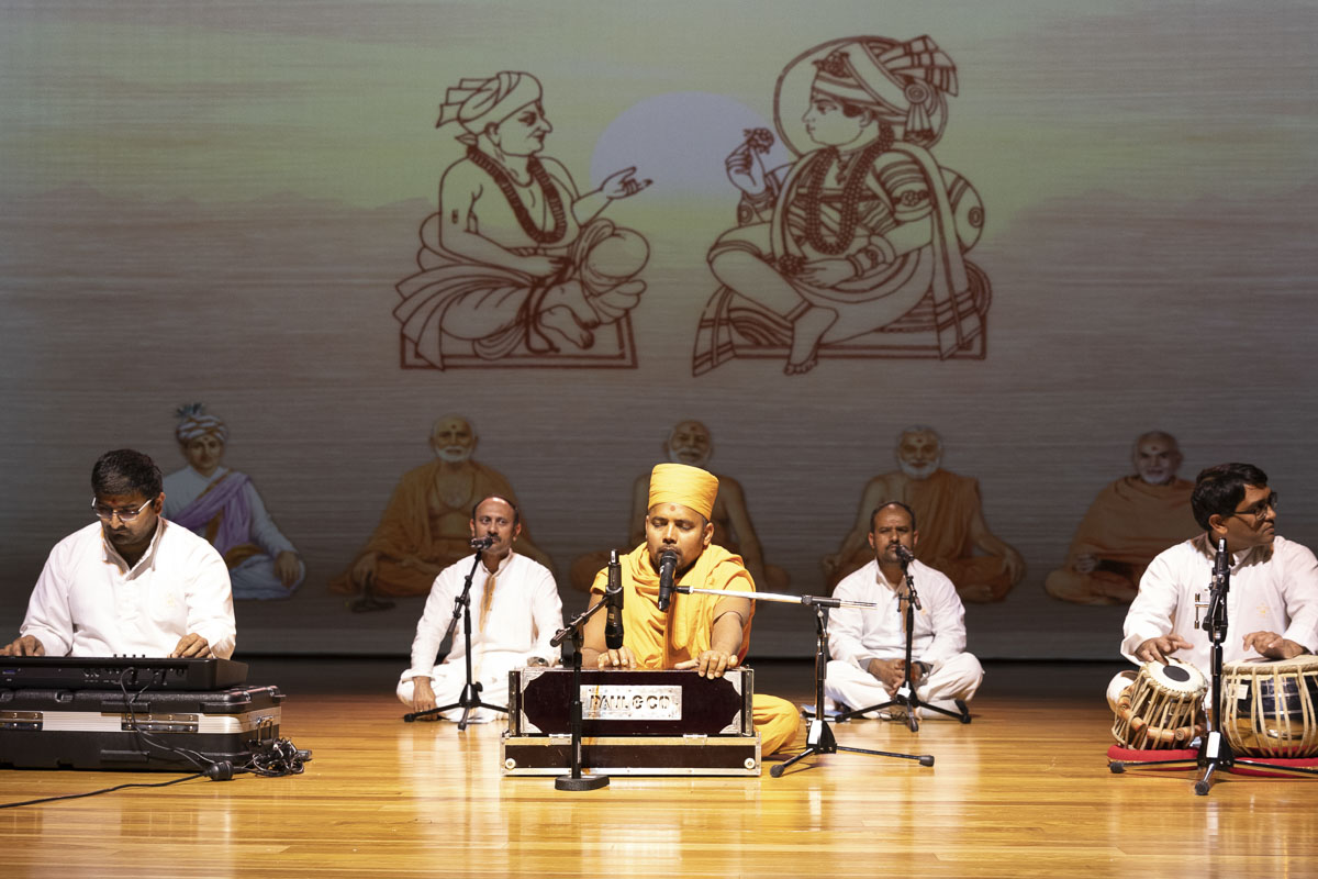 Sadhus and youths sing kirtans in the assembly