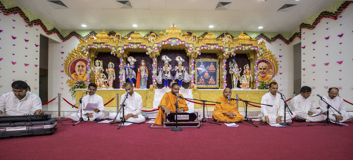 Sadhus and youths sing kirtans in the assembly