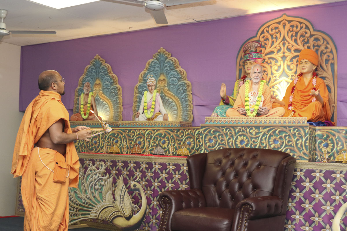 A swami performs the arti
