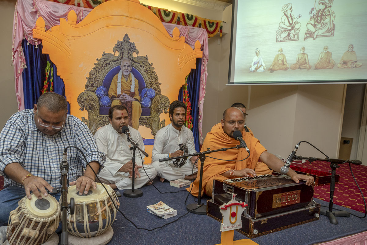 Sadhus and youths sing kirtans in the assembly