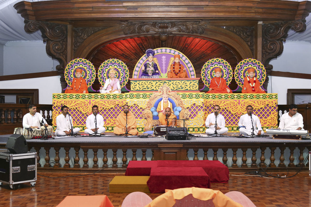 Sadhus and youths sing kirtans in the assembly