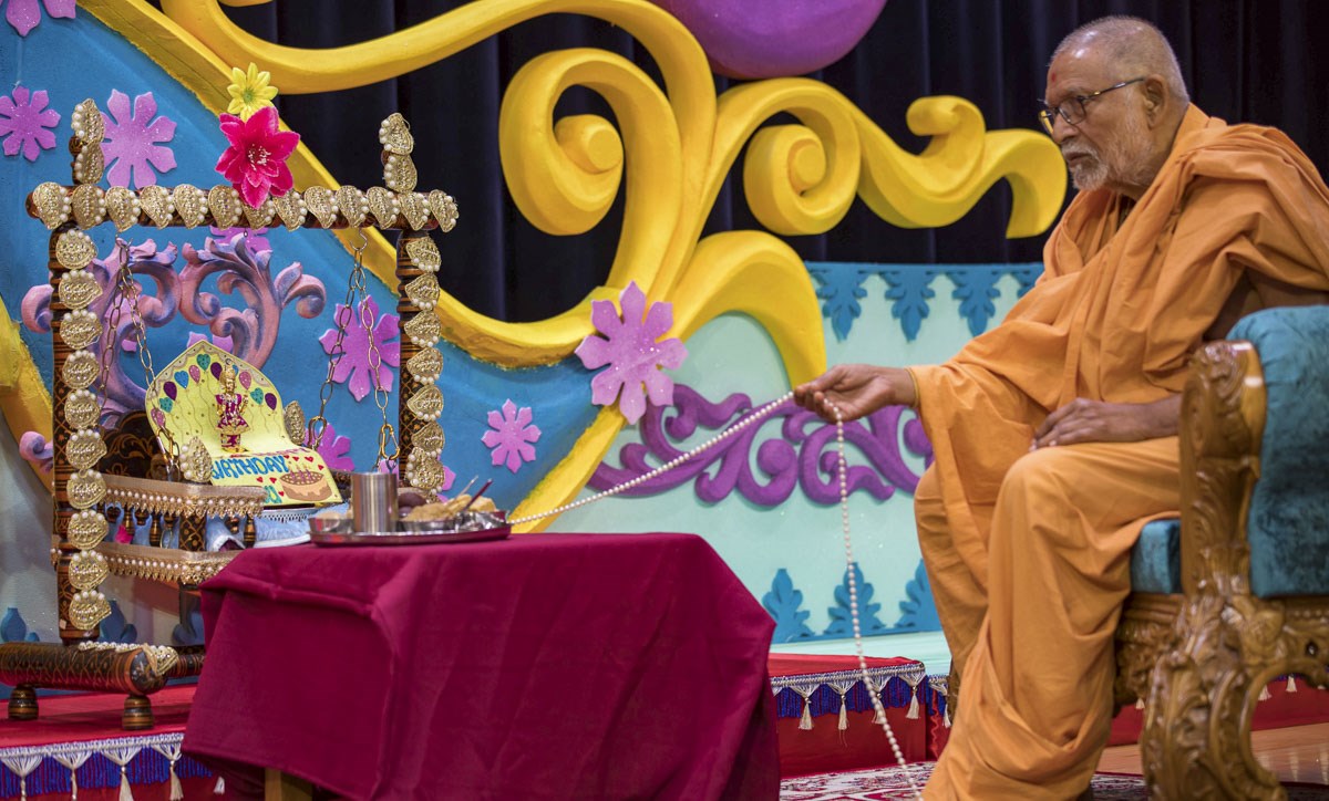 Pujya Kothari Swami swings Shri Harikrishna Maharaj in a hindolo
