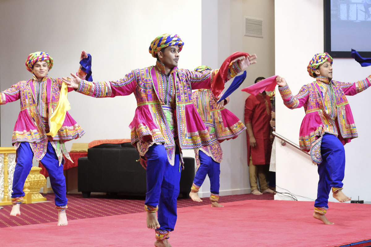 Youths perform a traditional dance in the welcome assembly