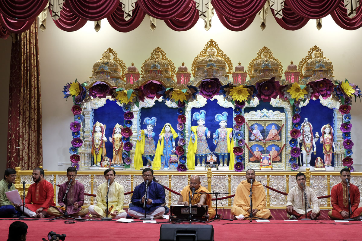 Sadhus and youths sing kirtans in the assembly