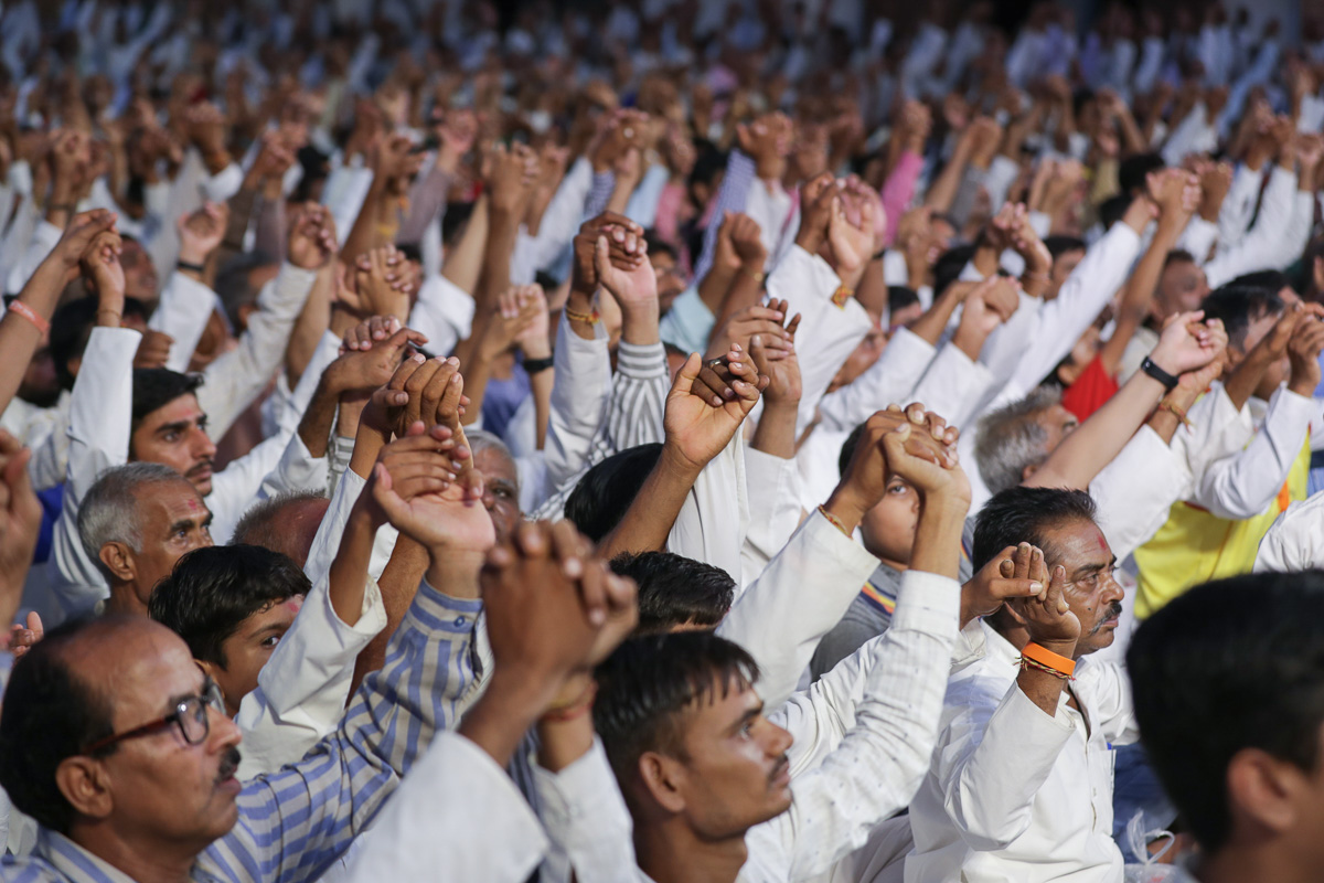 Devotees join hands in a gesture of unity