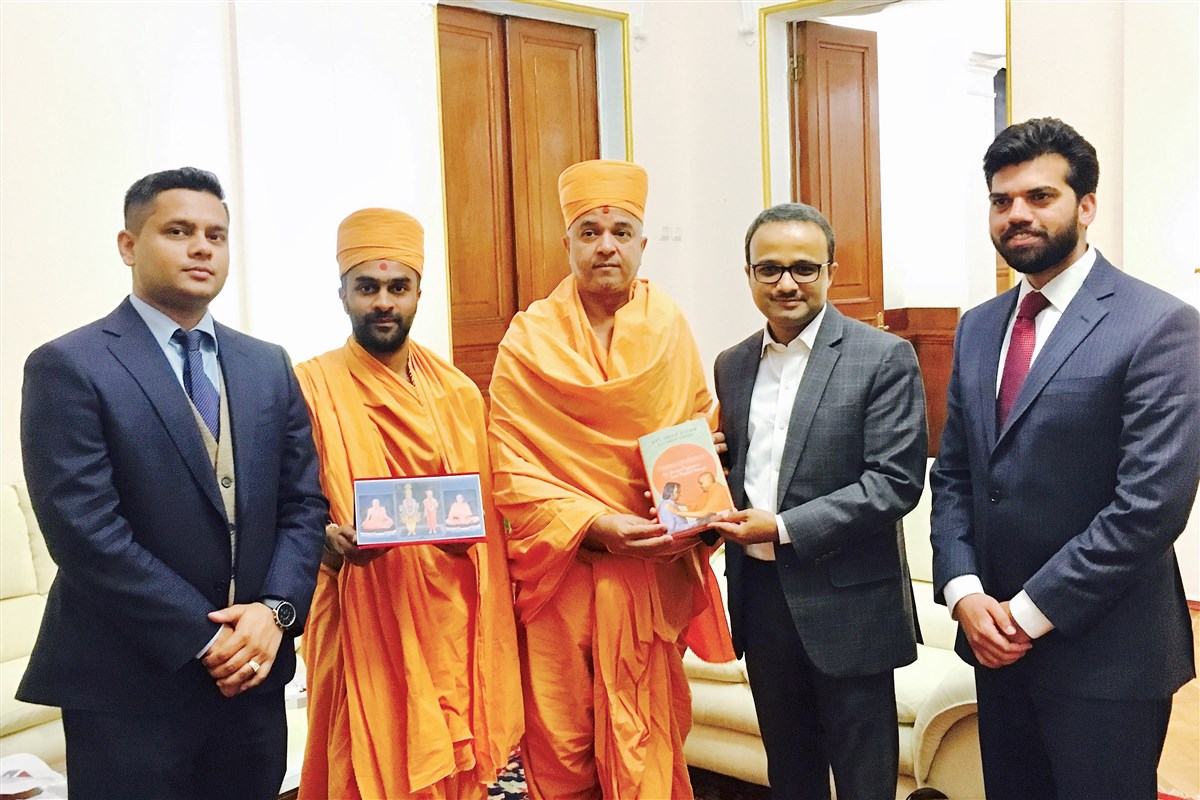 Pujya Brahmavihari Swami gifts a copy of 'Transcendence' to Deputy Chief of Mission Shri Binaya Pradhan, Moscow