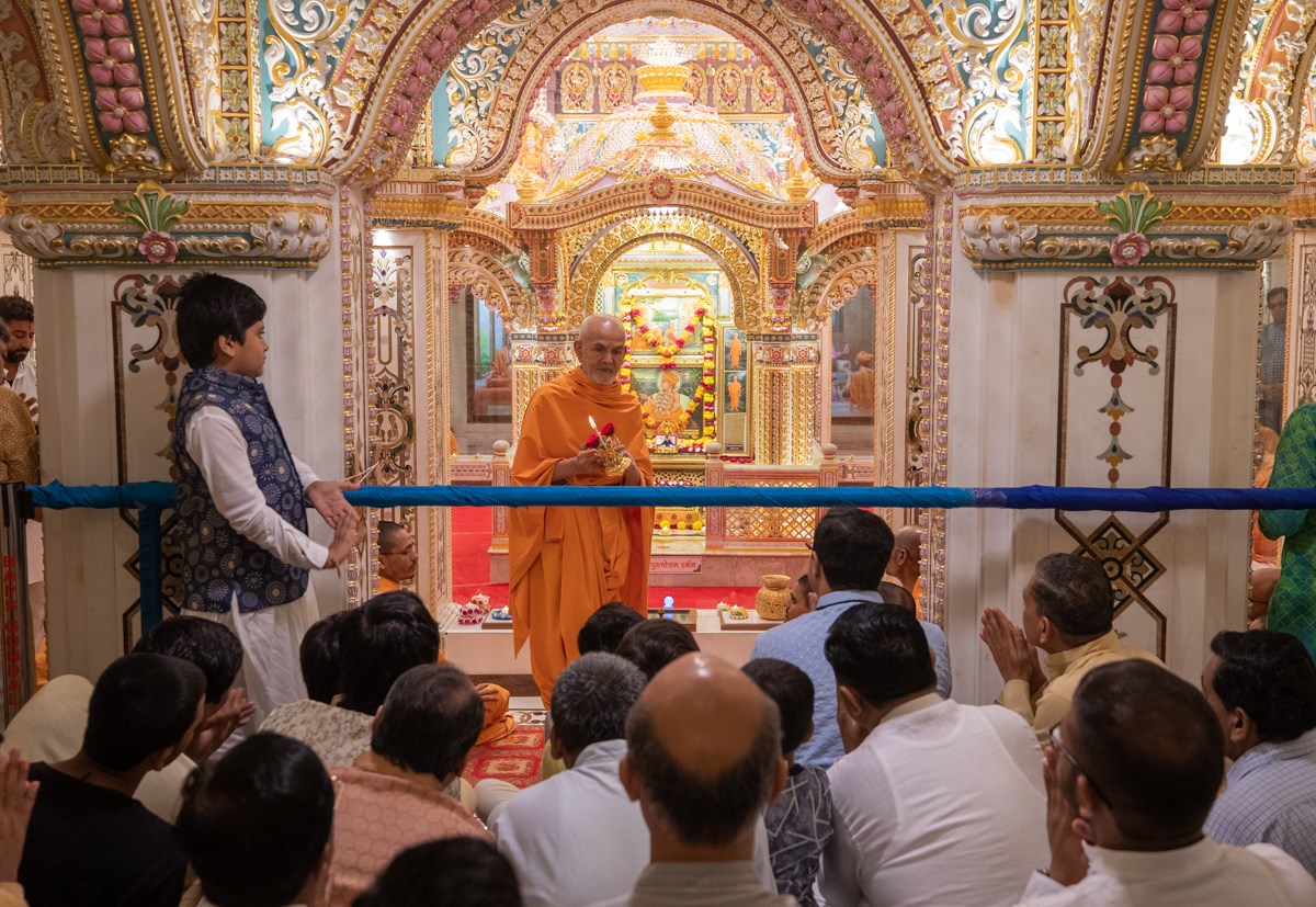 Swamishri performs the morning arti in the Akshar Deri