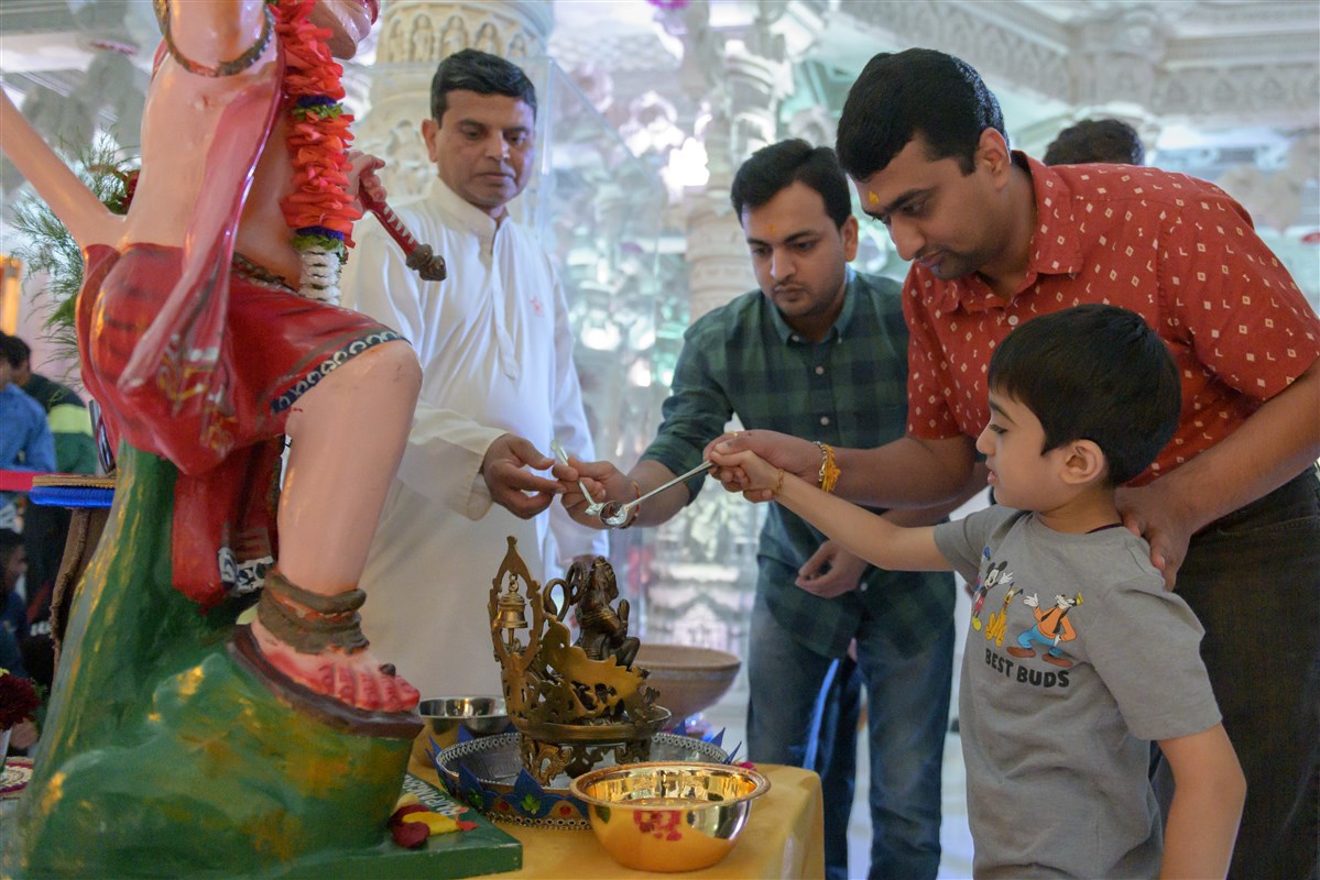 Devotees engaged in the pujan rituals