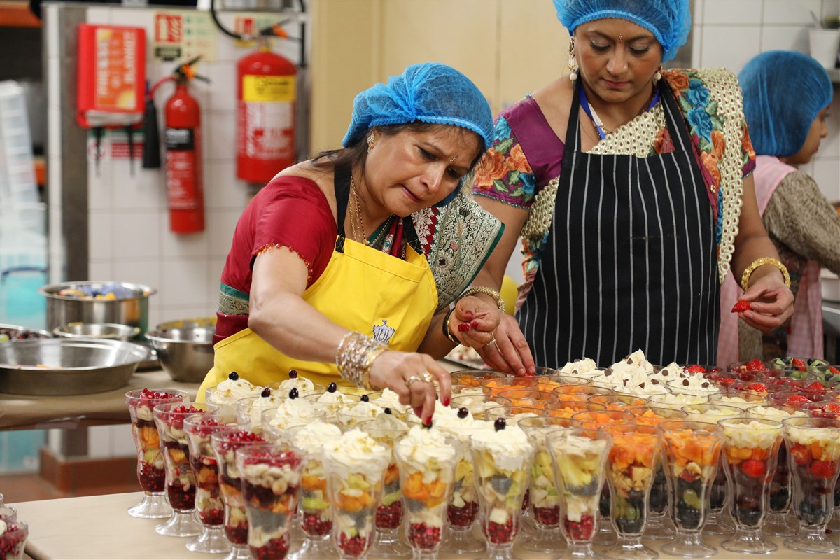 Volunteers prepare various desserts for the annakut