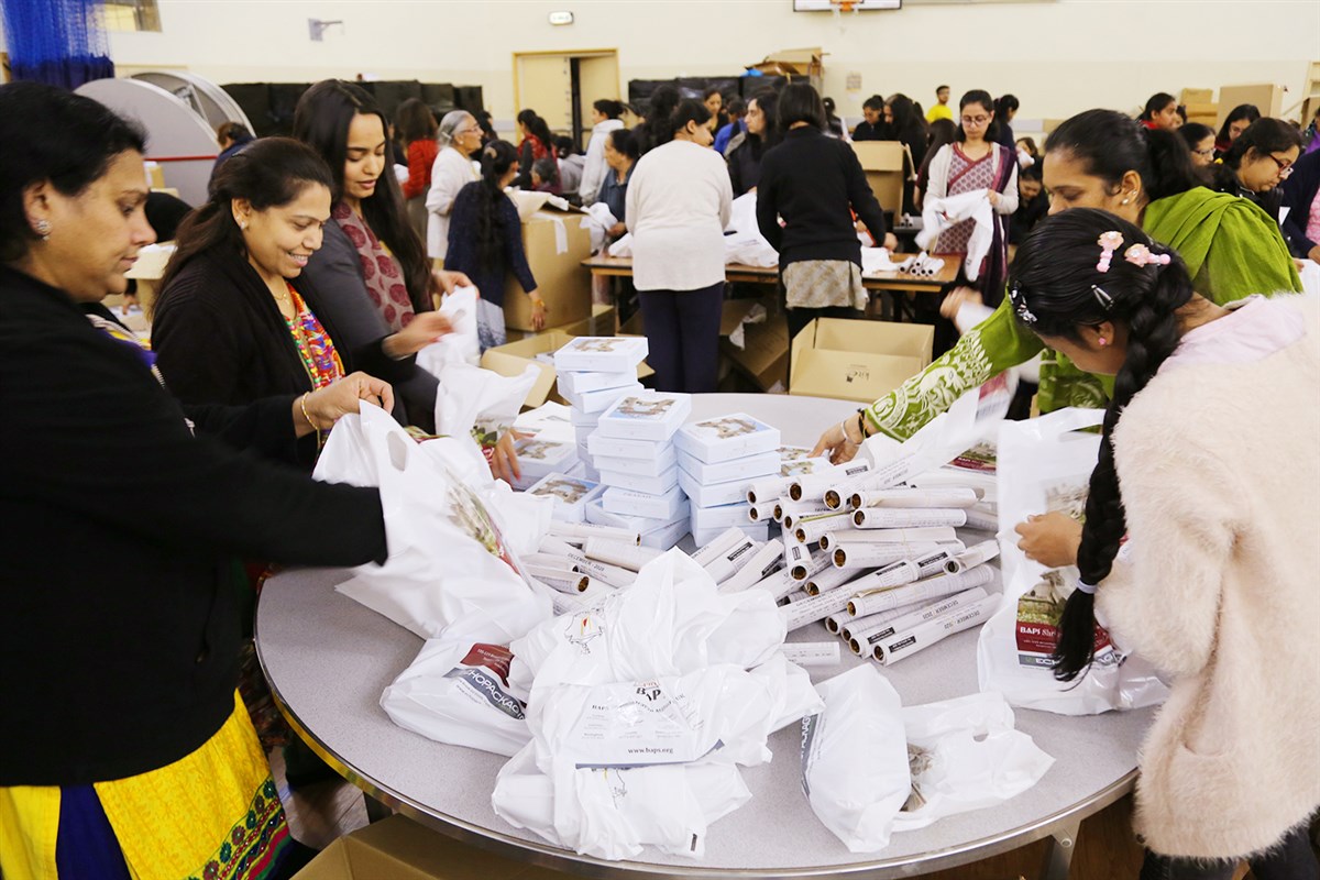 Volunteers prepare gift packs for visitors