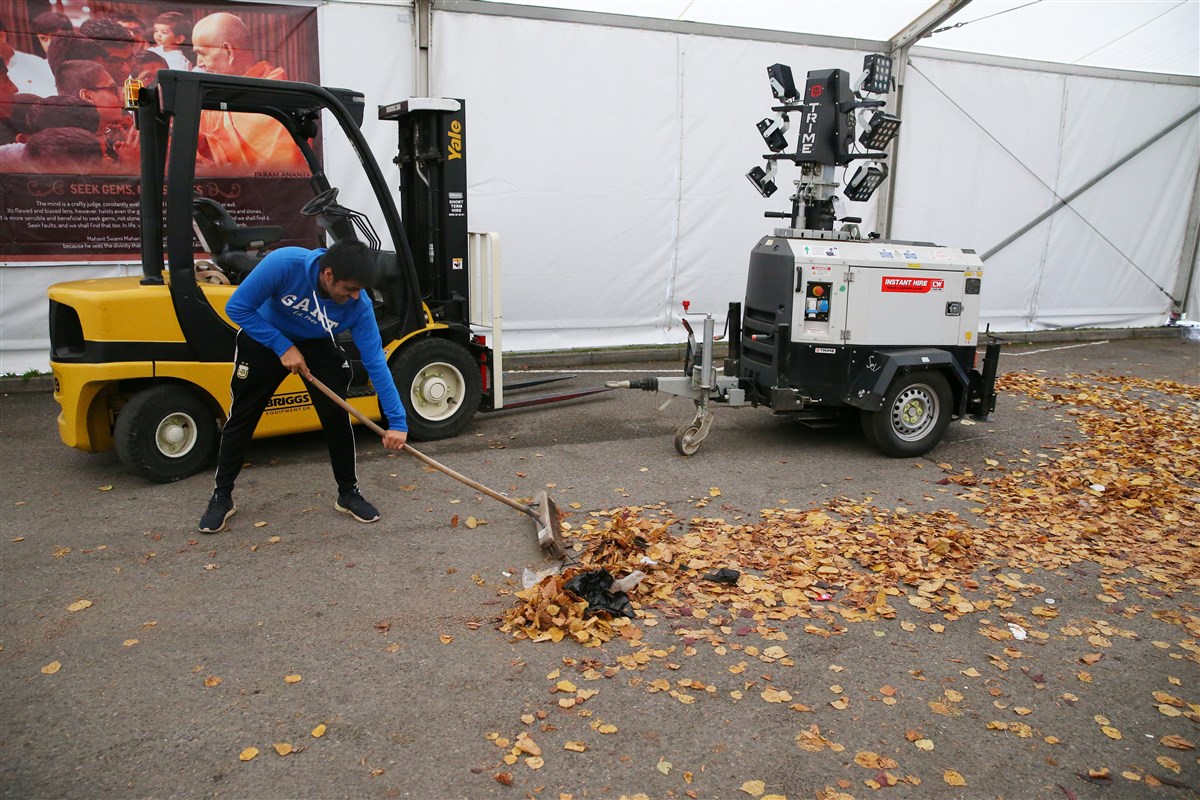 Volunteers help clean the grounds inside the marquees