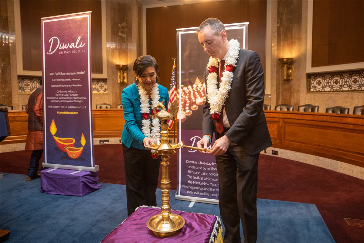 Reps. Judy Chu (CA-27) and Brian Fitzpatrick (PA-1) participate in the traditional lighting of the diya