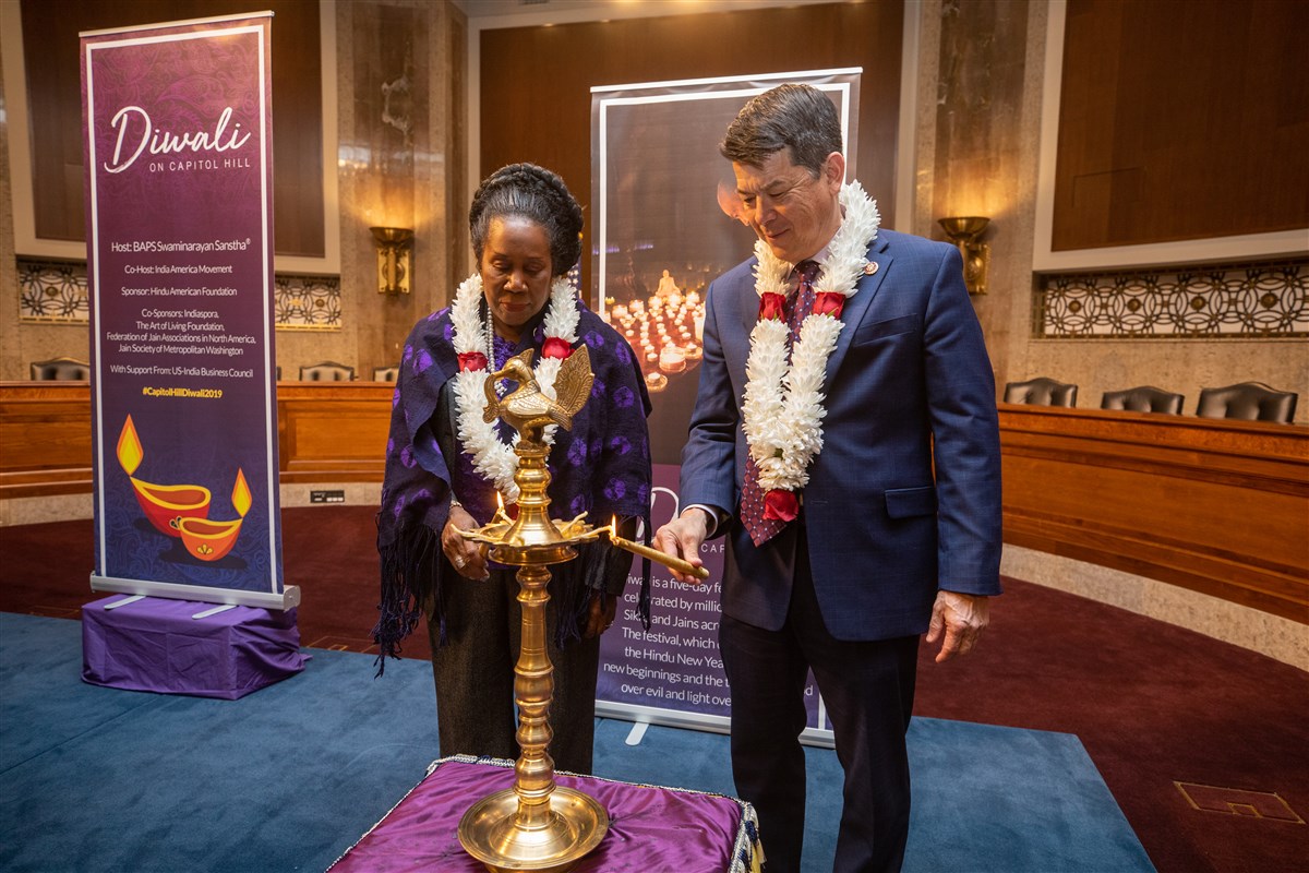 Reps. Sheila Jackson Lee (TX-18) and TJ Cox (CA-21) participate in the traditional lighting of the diya