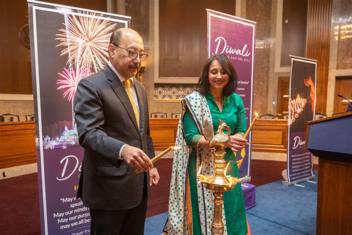 Ambassador Shringla and Hindu American Foundation Executive Director Suhag Shukla participate in the traditional lighting of the diya