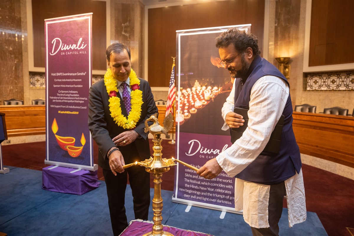 Rep. Raja Krishnamoorthi (IL-8) and India America Movement Founder Anand Shah participate in the traditional lighting of the diya