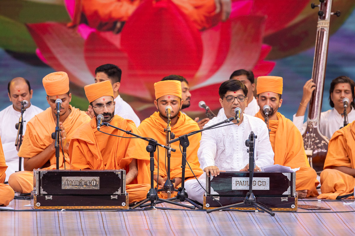 Sadhus and youths sing kirtans in the assembly
