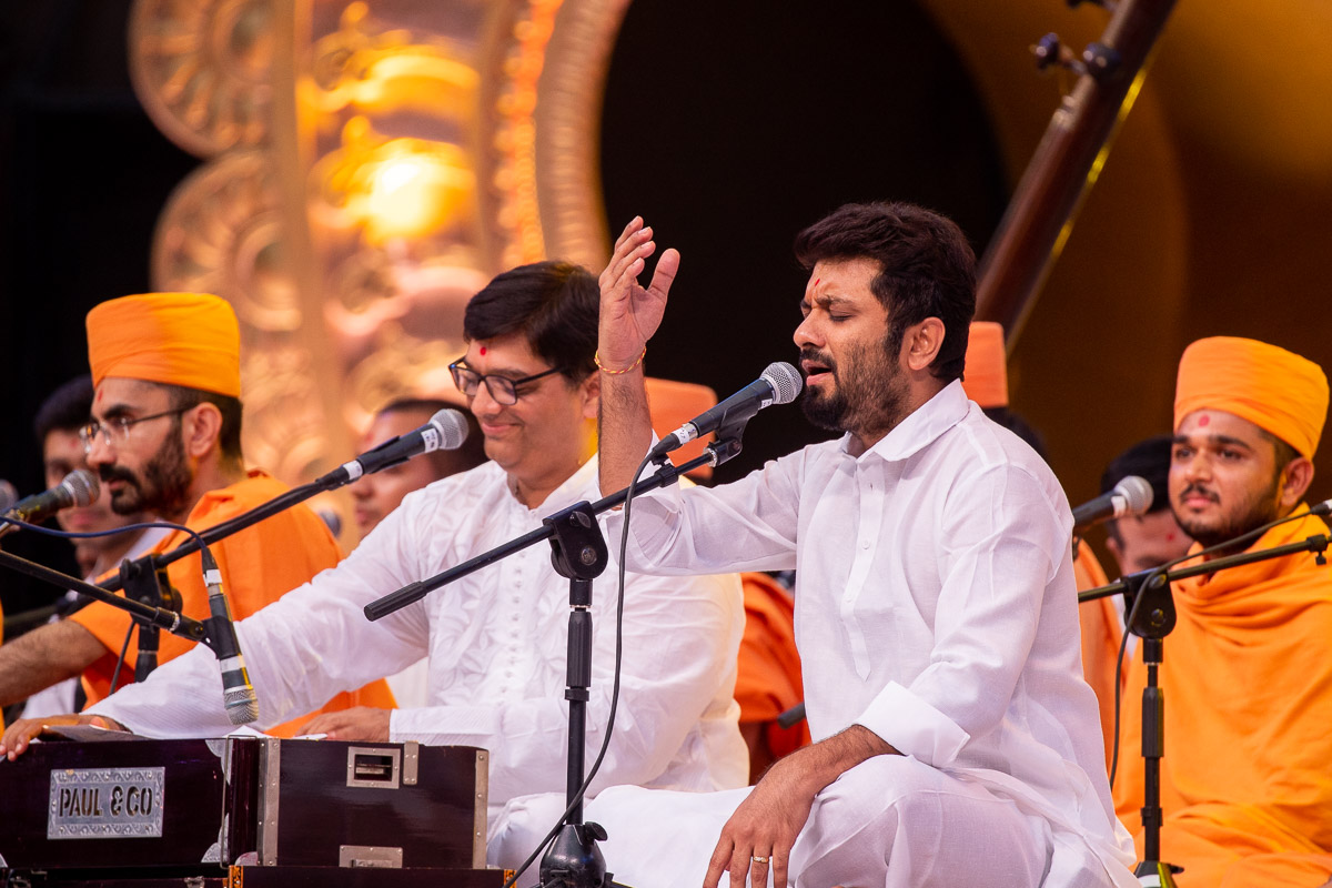 Sadhus and youths sing kirtans in the assembly