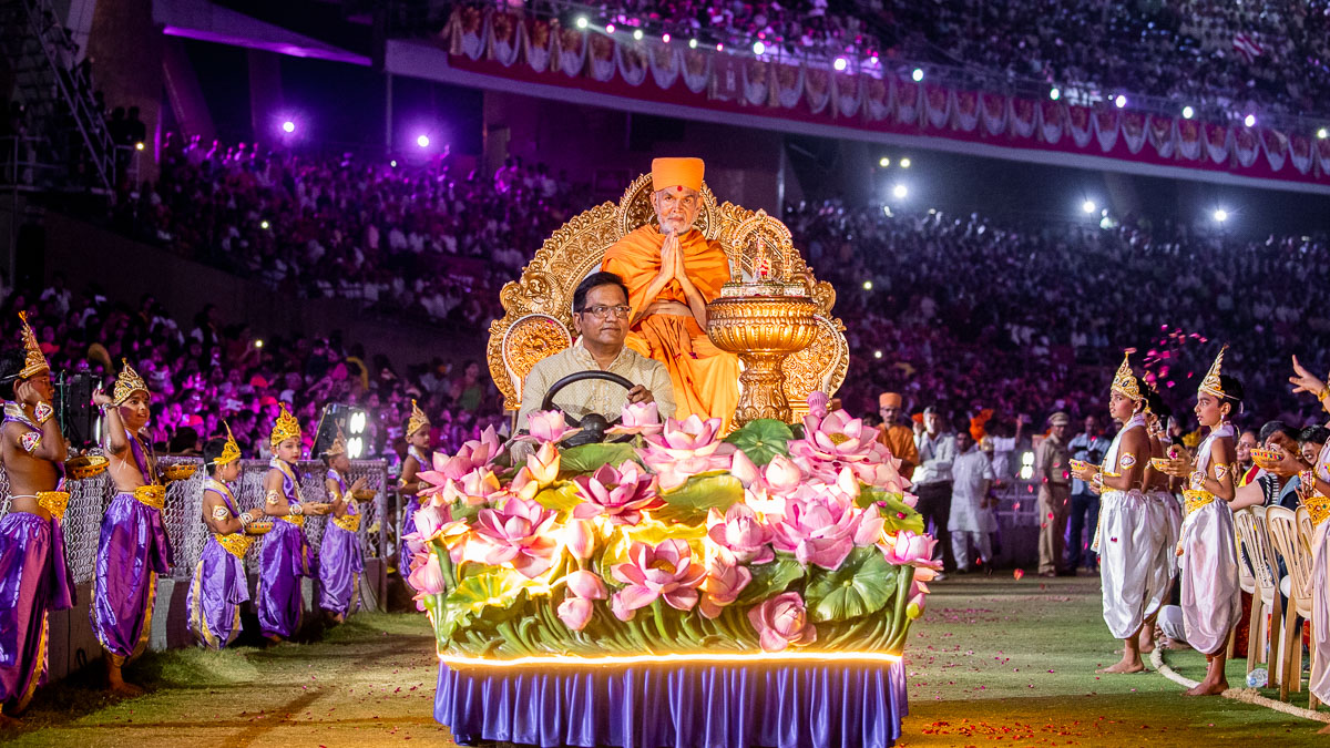 Swamishri in a decorated chariot