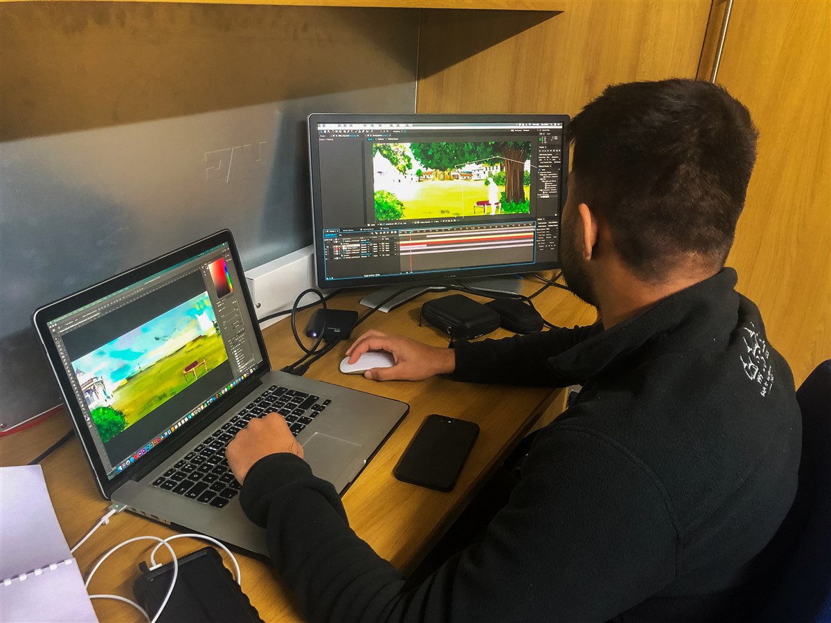 A video-editing volunteer begins to animate artwork created to form backdrops within the production