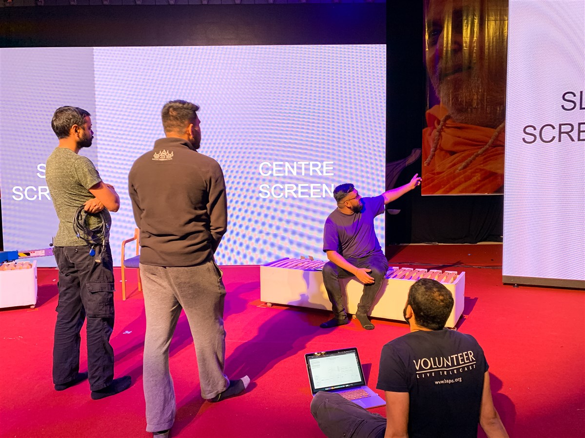 Audio-visual volunteers prepare the LED screens for content