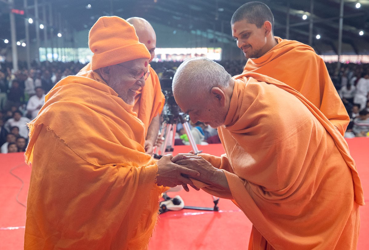 Swamishri greets Pujya Ghanshyamcharan Swami