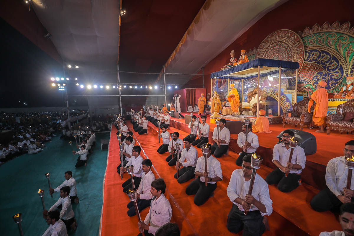 Youths with mashals during the arti