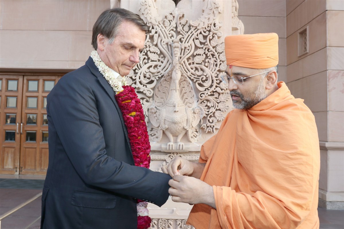 Brazilian President Jair Bolsonaro traditionally greeted at Swaminarayan Akshardham in New Delhi by Gnanmuni Swami
