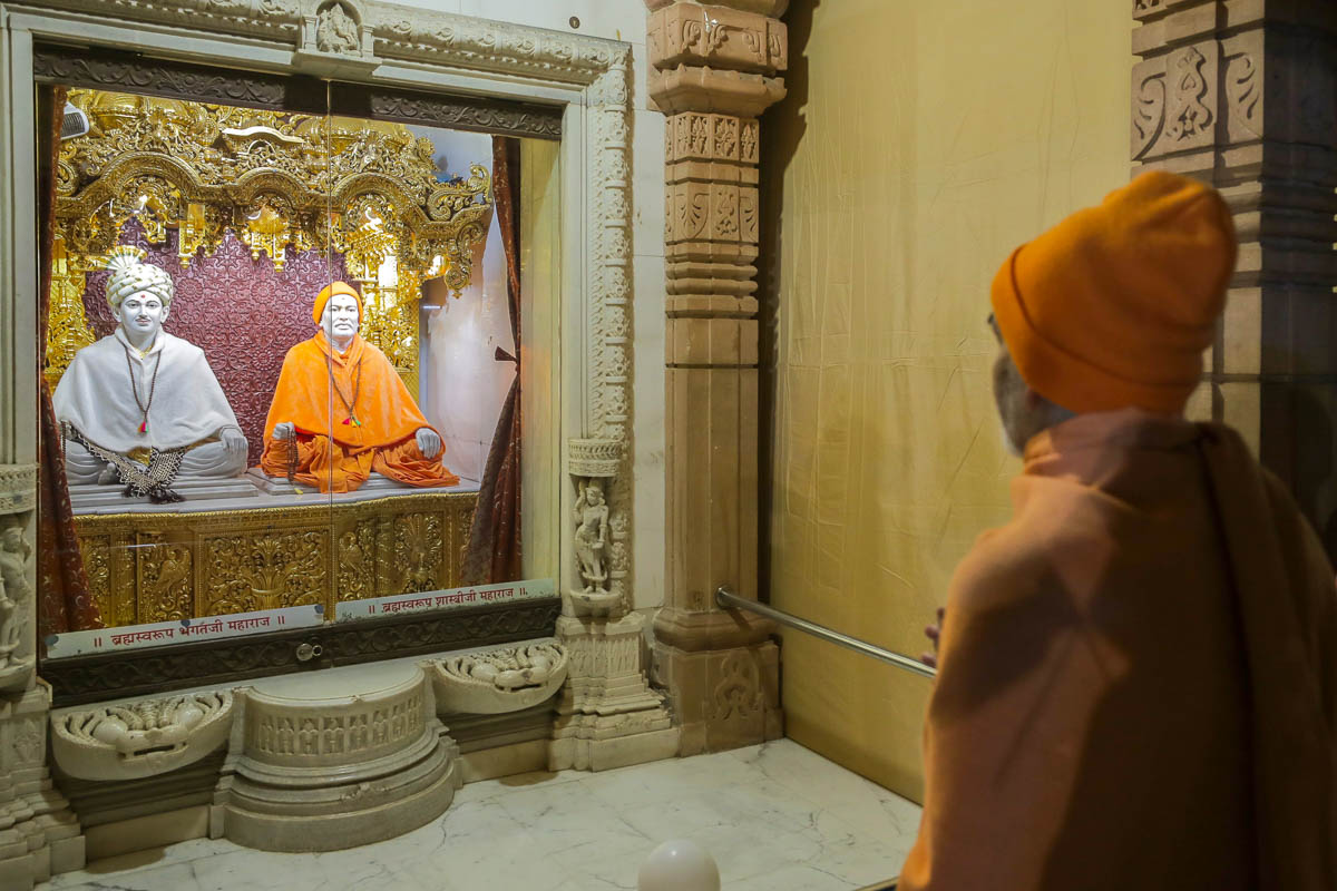 Swamishri engrossed in darshan of Brahmaswarup Bhagatji Maharaj and Brahmaswarup Shastriji Maharaj