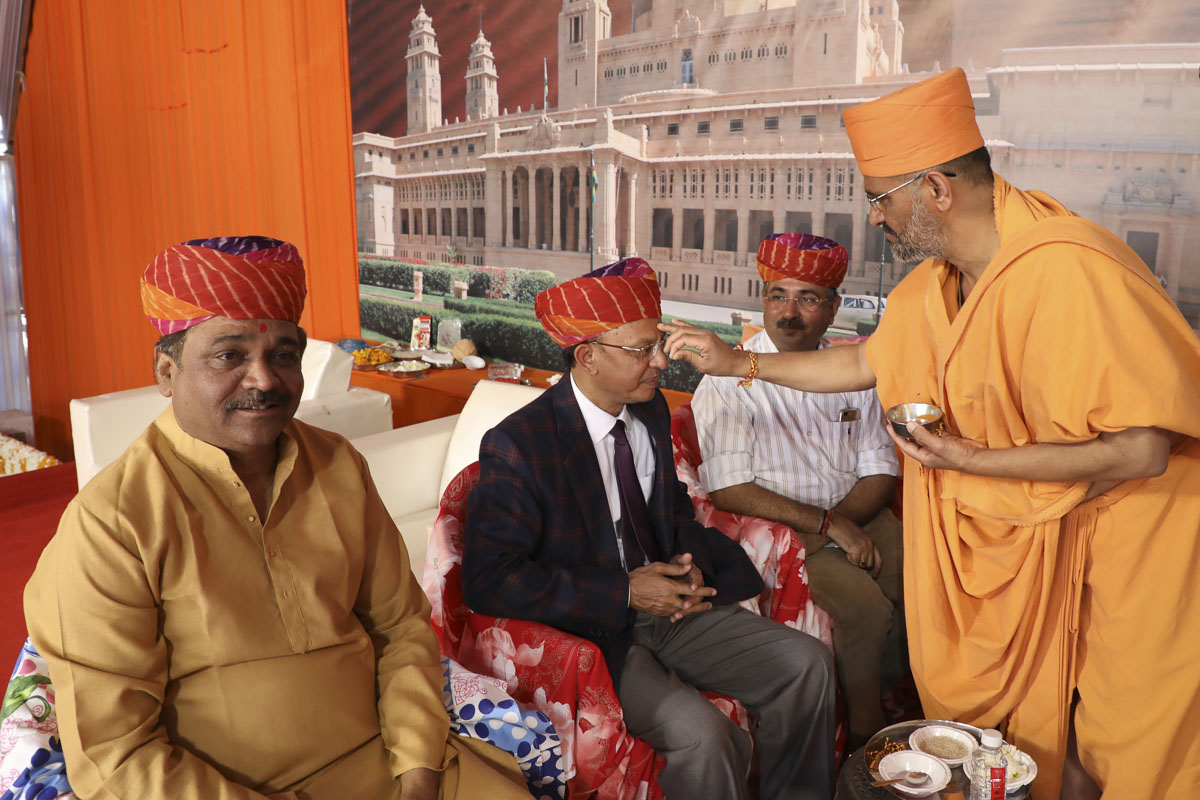 Sadhus apply chandlo at the beginning of the mahapuja