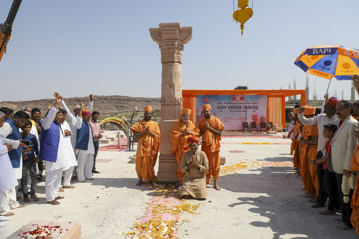 Pujya Ishwarcharan Swami and saints with Shri Gauravbhai Shah in front of the first stone pillar