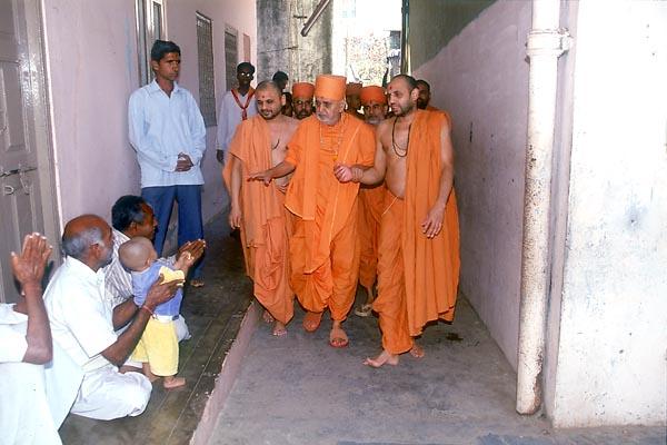  Swamishri blesses devotees, young and old, while on his way for darshan to the birthplace of Shastriji Maharaj
