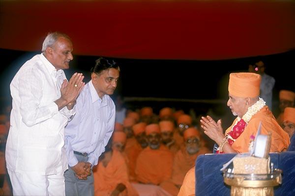  On behalf of Charutar Vidya Mandal Shri C. L. Patel and Shri H. K. Patel garland and honor Swamishri